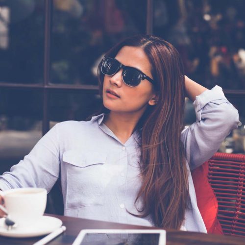 Asian woman drinking coffee in vintage color tone Asian woman drinking coffee in vintage color tone