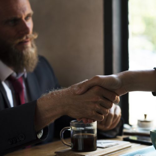 Business agreement handshake at coffee shop Business agreement handshake at coffee shop