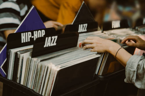 Woman is choosing a vinyl record in a musical store