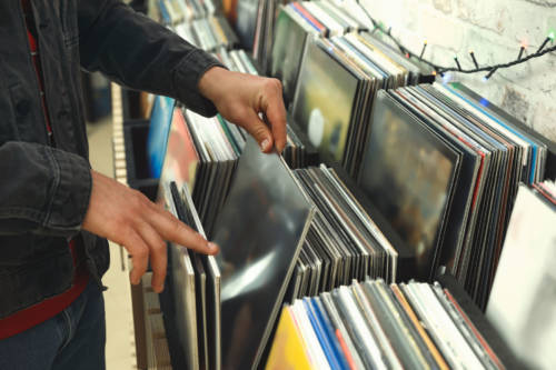Man choosing vinyl records in store, closeup