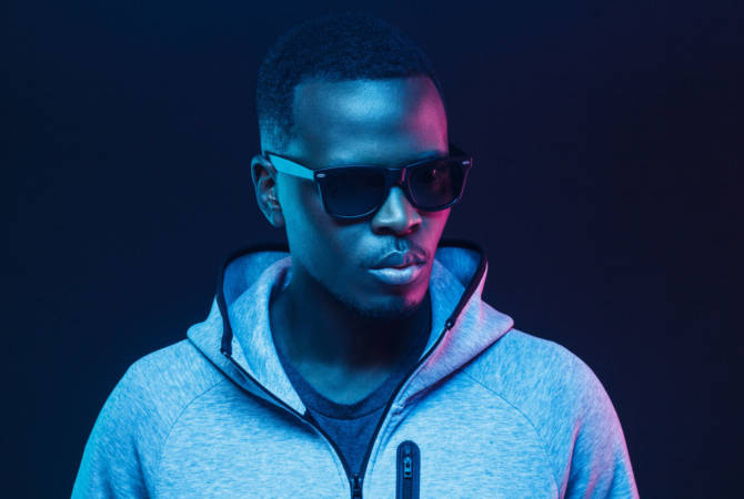 Close-up portrait of stylish black man, wearing hoodie and sunglasses