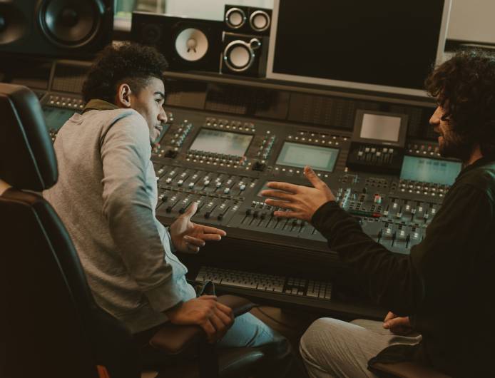 young musicians talking at recording studio young musicians talking at recording studio
