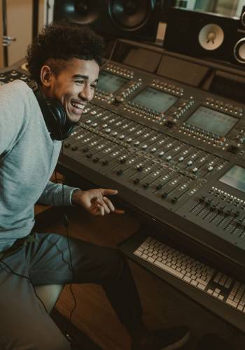 happy young sound producer sitting at studio happy young sound producer sitting at studio