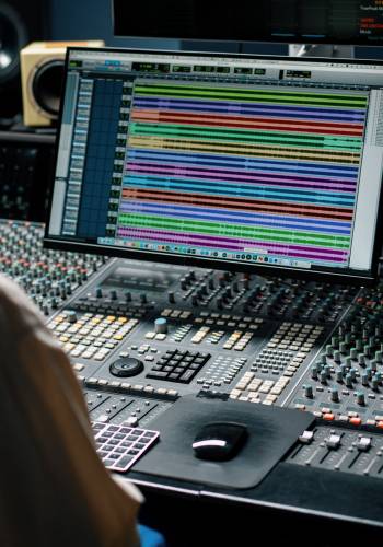 Sound engineer working in music studio with monitors and equaliz Sound engineer working in music studio with monitors and equaliz